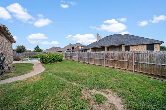View of yard featuring a fenced backyard and a fenced in pool | Image 39