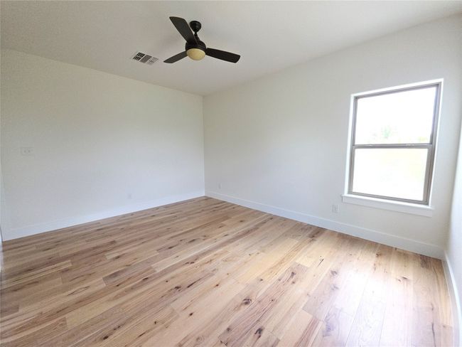 Unfurnished room with light wood-style flooring, a ceiling fan, and baseboards | Image 19