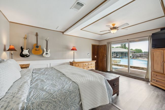 Primary Bedroom has an Amazing Pool View with Sliding Door Access | Image 22