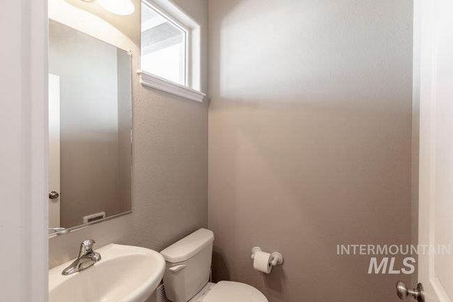 Bathroom featuring toilet and a sink | Image 12