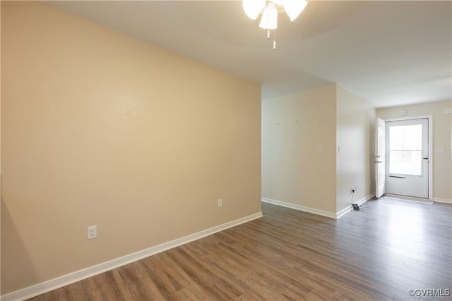 Unfurnished room featuring baseboards, dark wood-type flooring, and a ceiling fan | Image 12
