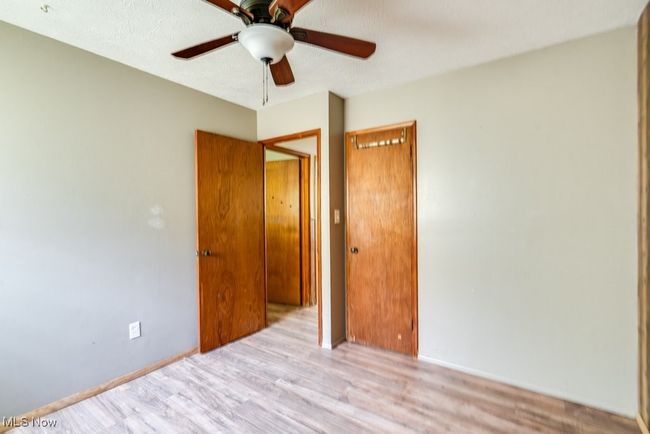 Spare room featuring wood finished floors, a ceiling fan, and baseboards | Image 26