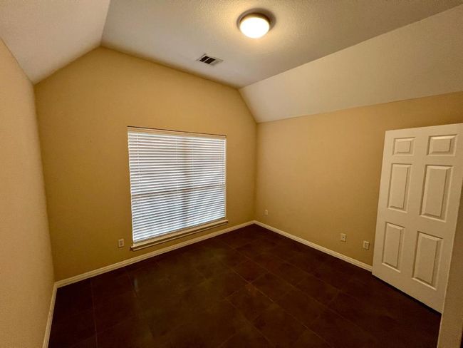 Additional living space with lofted ceiling and dark tile patterned flooring | Image 13