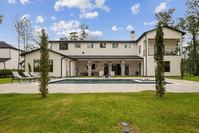 Backyard featuring a stunning lake view, a luxurious pool and jacuzzi, a fully equipped outdoor kitchen, and a spacious covered patio—perfect for relaxation and entertainment. | Image 41