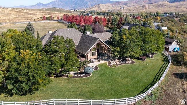 Aerial view of property and surrounding area featuring a mountain backdrop | Image 9
