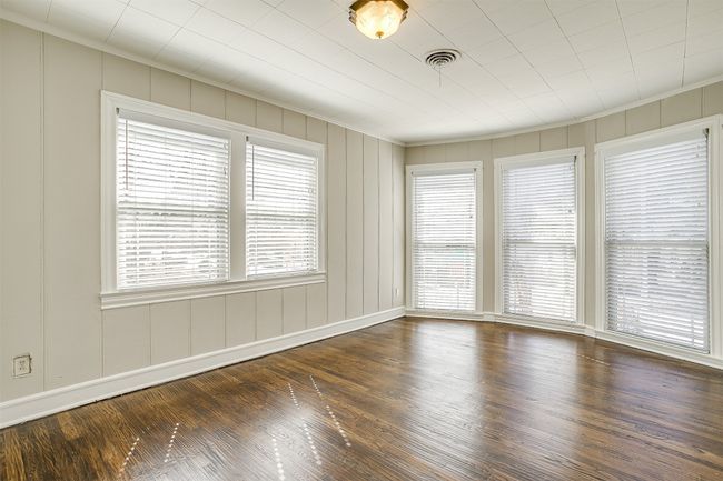 Spare room featuring wood finished floors, ornamental molding, and a decorative wall | Image 11