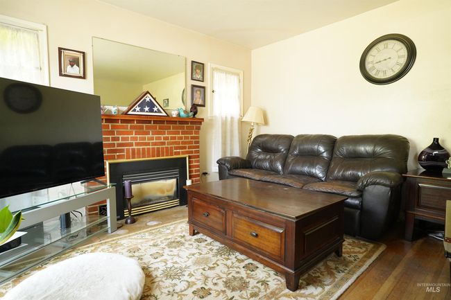 Living area featuring hardwood / wood-style flooring and a fireplace | Image 5