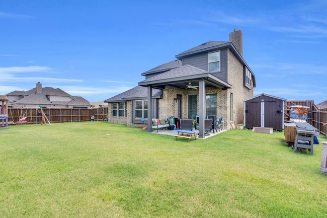 Back of structure featuring covered patio | Image 34