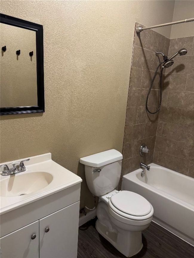 Bathroom with vanity, wood finished floors, and shower / tub combination | Image 6