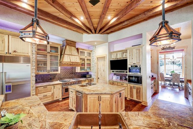 The kitchen includes a built in steamer, professional coffee maker, and trash compactor. | Image 16