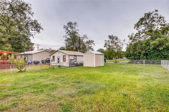 View of yard featuring a shed and an outbuilding | Image 28