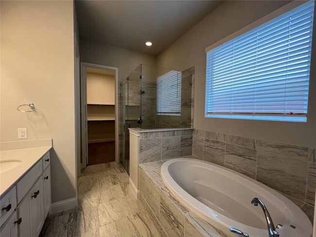 Bathroom with a shower stall, vanity, a garden tub, baseboards, and marble finish floors | Image 11