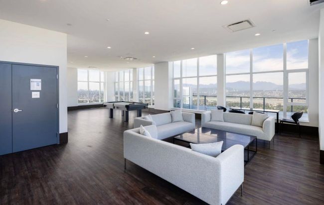 Living room featuring floor to ceiling windows, a mountain view, visible vents, and dark wood-style flooring | Image 15