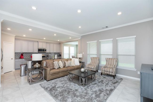 Open-concept living area creating a seamless flow ideal for entertaining. | Image 9