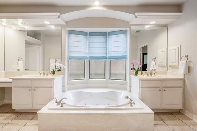 The bathroom offers lots of natural and overhead lighting that makes this the ideal place to get ready for your day or evening out. | Image 24