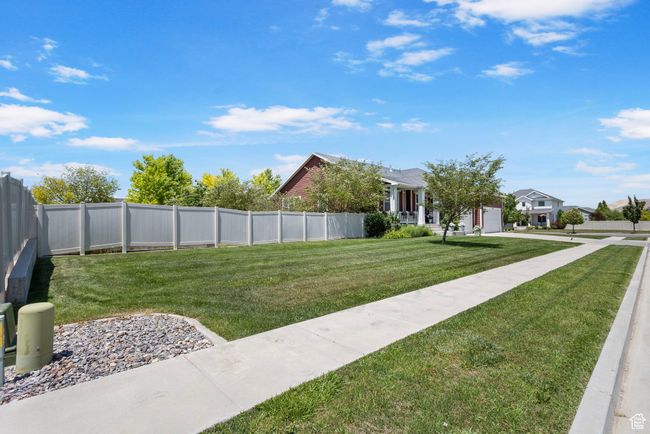Fenced yard featuring a garage and driveway | Image 4