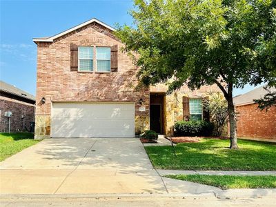 Front facade featuring a front lawn and a garage | Image 1