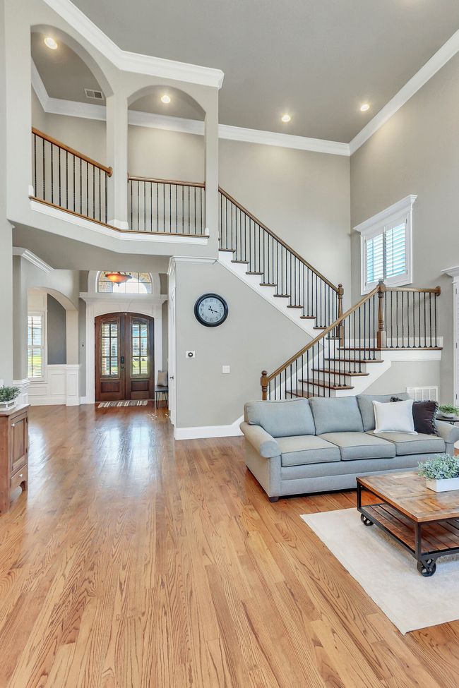 Thoughtful, custom design can be seen in the repeating arches that open the view to the downstairs. | Image 7