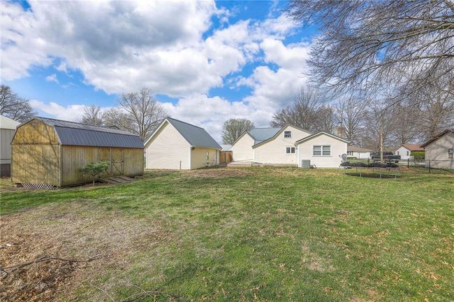 View of yard with an outbuilding, fence, and a storage shed | Image 8