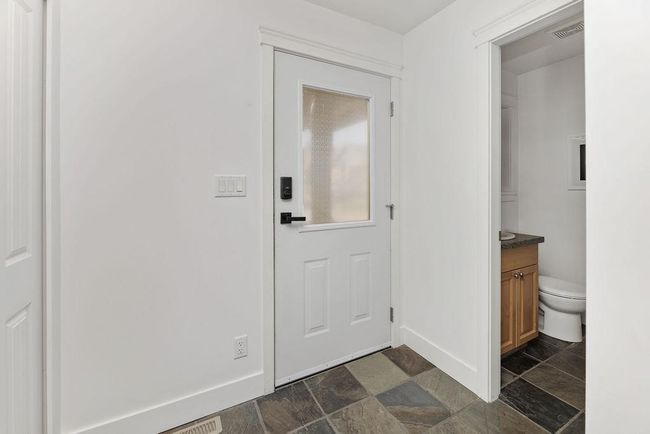 Entry way with ample closet space and half bath on main floor | Image 16