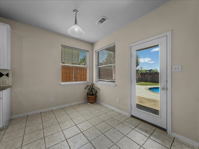 Unfurnished dining area with plenty of natural light and light tile patterned floors | Image 10