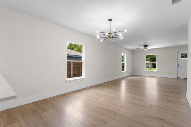 Spare room with a chandelier, a ceiling fan, and light wood finished floors | Image 15