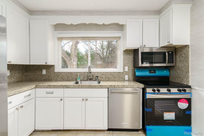 kitchen with new stainless steel appliances | Image 10
