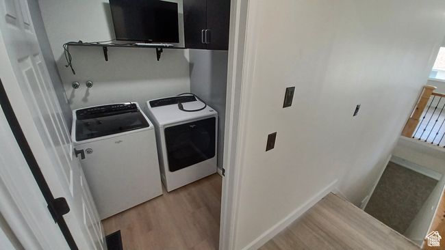 Washroom featuring independent washer and dryer and light wood-type flooring | Image 16