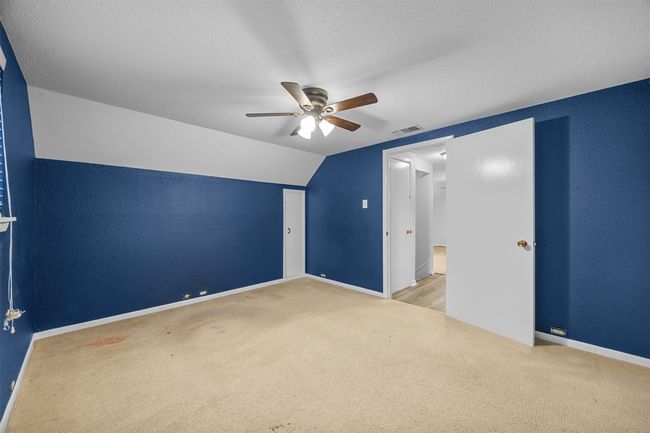 Bonus room with carpet flooring, a ceiling fan, baseboards, a textured ceiling, and vaulted ceiling | Image 21