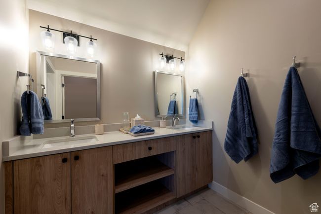 Bathroom featuring double vanity and lofted ceiling | Image 46