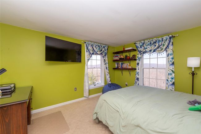 Carpeted bedroom featuring baseboards and multiple windows | Image 33