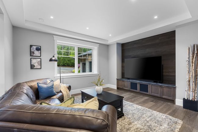 Living area with a tray ceiling, wood finished floors, baseboards, and recessed lighting | Image 16