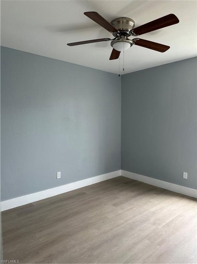 Empty room with wood finished floors and a ceiling fan | Image 19