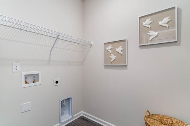 Laundry room featuring electric dryer hookup, washer hookup, and dark wood-style flooring | Image 19