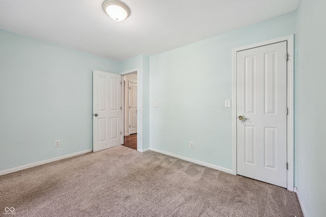 unfurnished bedroom with carpet flooring and baseboards | Image 21
