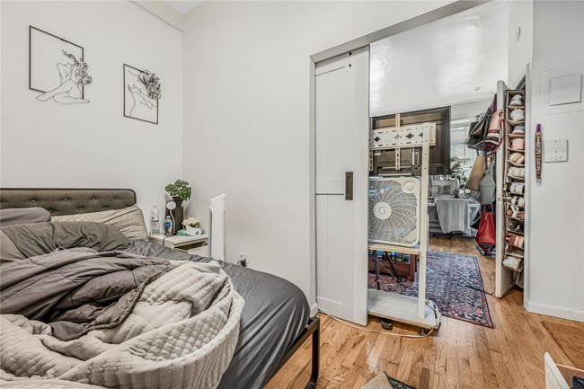 Bedroom with wood finished floors and baseboards | Image 11