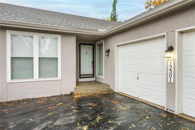 View of exterior entry featuring a garage | Image 2