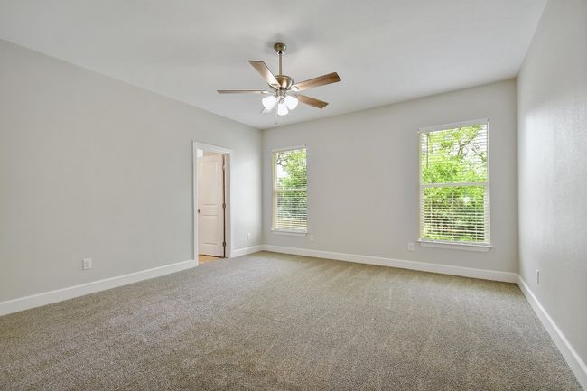 Empty room featuring ceiling fan and carpet | Image 14