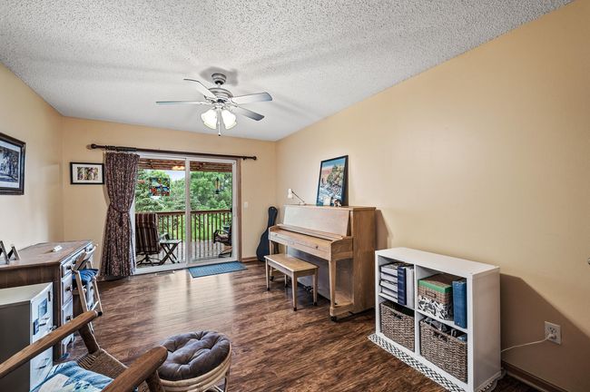 Transition into the piano room with easy access to your maintenance-free deck extending your living and entertaining space outdoors. | Image 12