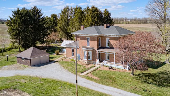view of front of house with an outbuilding, a front lawn, and a chimney | Image 74
