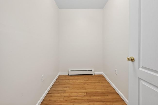 Office nook featuring light wood-type flooring, baseboard heating, and baseboards | Image 4
