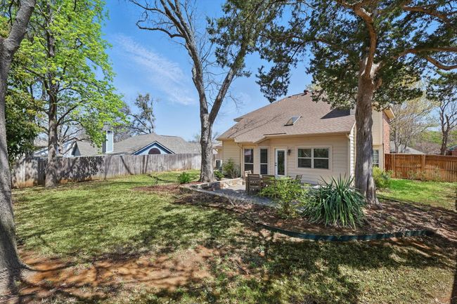 Fenced backyard with a patio | Image 30