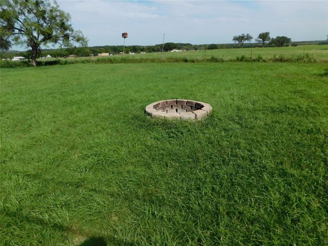 View of green lawn with a view of rural / pastoral area and an outdoor fire pit | Image 31