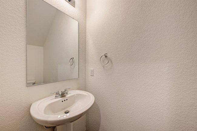 Bathroom with a textured wall and a sink | Image 15