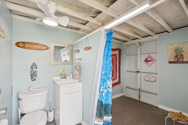 Pool house with toilet, sink and changing area with curtains for privacy. | Image 28