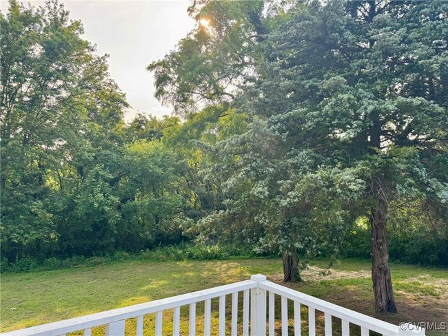 View of grassy yard with a forest view | Image 24