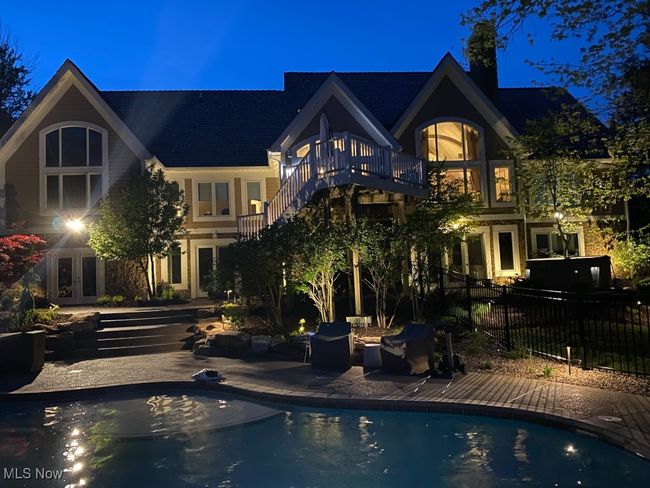 Rear view of property featuring a balcony, a patio area, a fenced in pool, french doors, and fence | Image 48