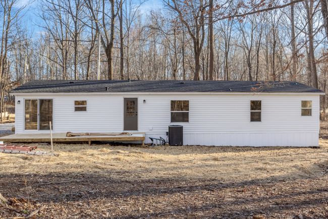 The brand-new back deck is perfect for outdoor entertaining, seamlessly connected to the home through new sliding glass doors that bring in natural light and provide easy access to the backyard. | Image 18