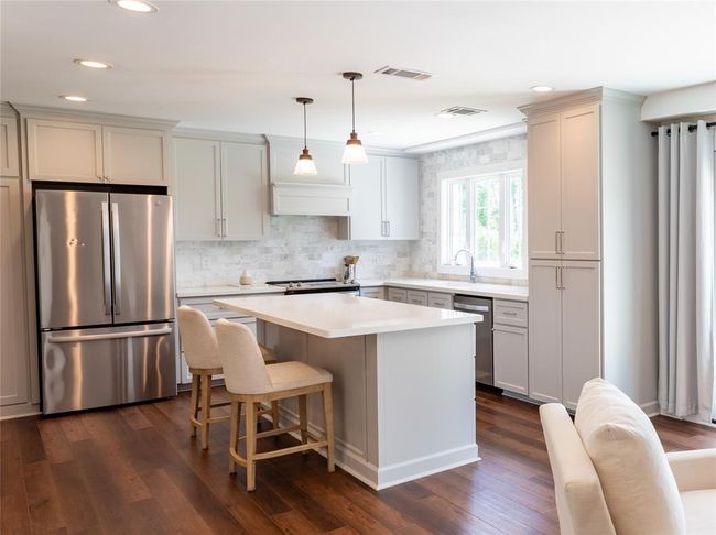 Kitchen has plenty of lighting and overlooks the massive backyard | Image 6