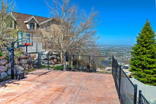 View of patio / terrace with fence and basketball court | Image 65